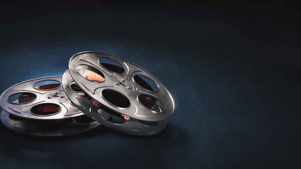 Film reels on a dark blue background / 3D rendering, illustration