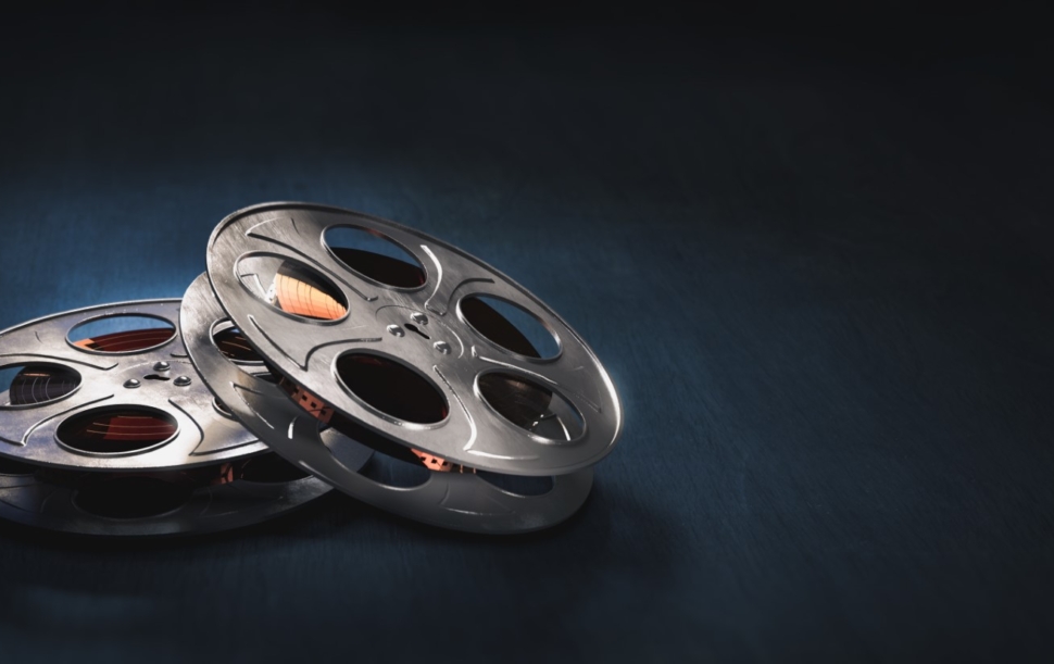 Film reels on a dark blue background / 3D rendering, illustration